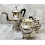 A French Empire taste three piece tea service, the teapot spout terminating in phoenix mask with