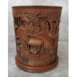 A Chinese bamboo 'scholars' brush pot, Bitong, the cylindrical brushpot is supported on three
