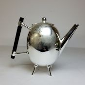 A silver plated teapot, after a design by Dr Christopher Dresser, of ovoid form, tube spout,