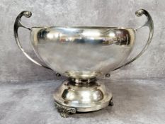 A silver two handled circular rose bowl, scroll handles, spreading circular foot, raised on three