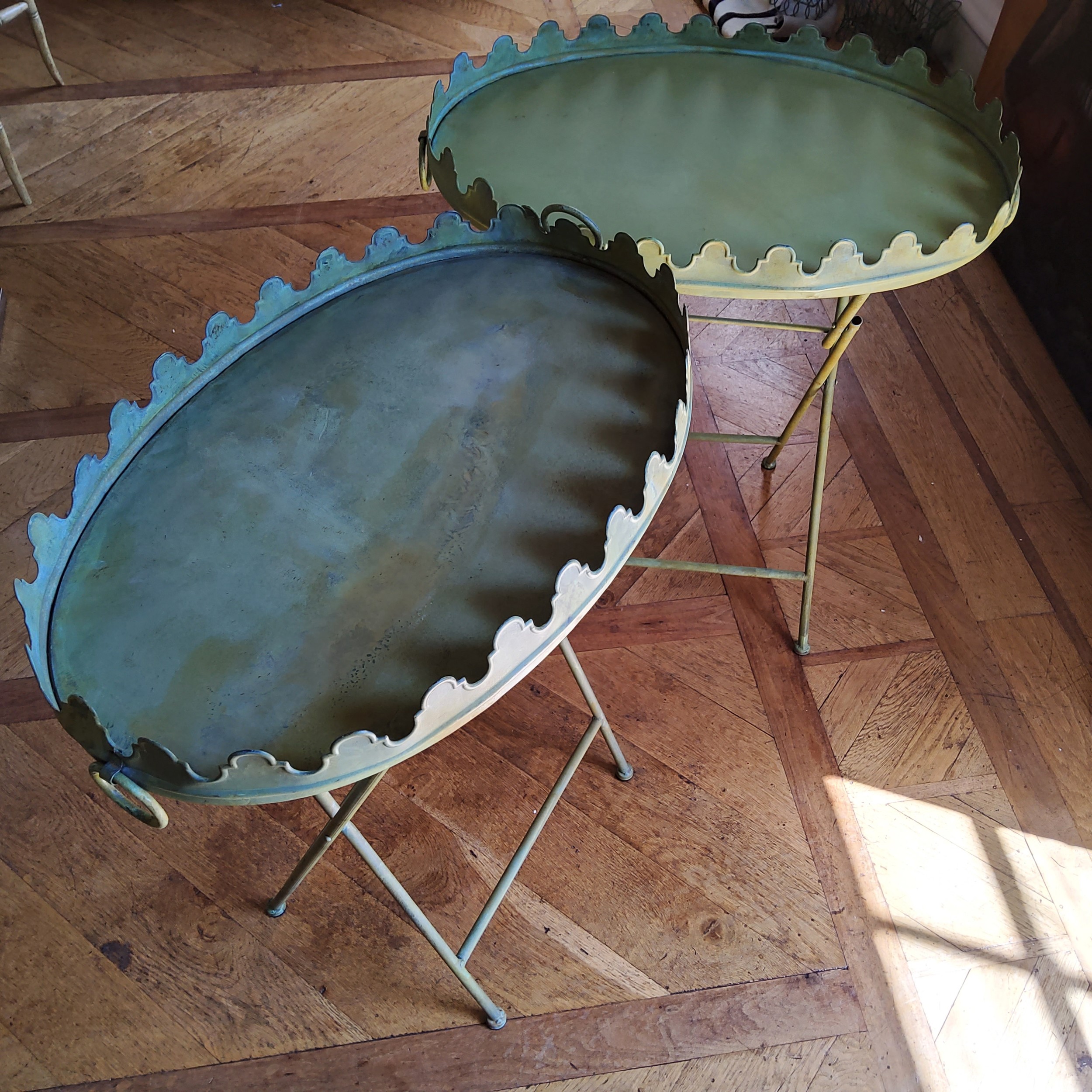 A pair of French style oval garden tables painted green metal, swing handles, raised shaped rim 65 w
