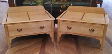 A pair of 20th century limed oak luggage stands with fixed guilt metal protective runners, one