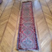 A hand knotted Persian Sarab runner, in tones of turquoise and rich reds, 411cm long x 90cm