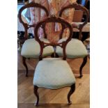 Three carved mahogany balloon back salon chairs, cabriole legs, green upholstered seat, studwork