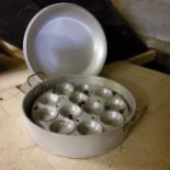 Kitchenalia - a substantial twelve egg poaching pan and cover 40cm diameter x 13cm H
