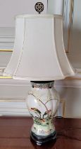 An Oriental hand painted ceramic baluster shaped lamp base decorated with parrots in a