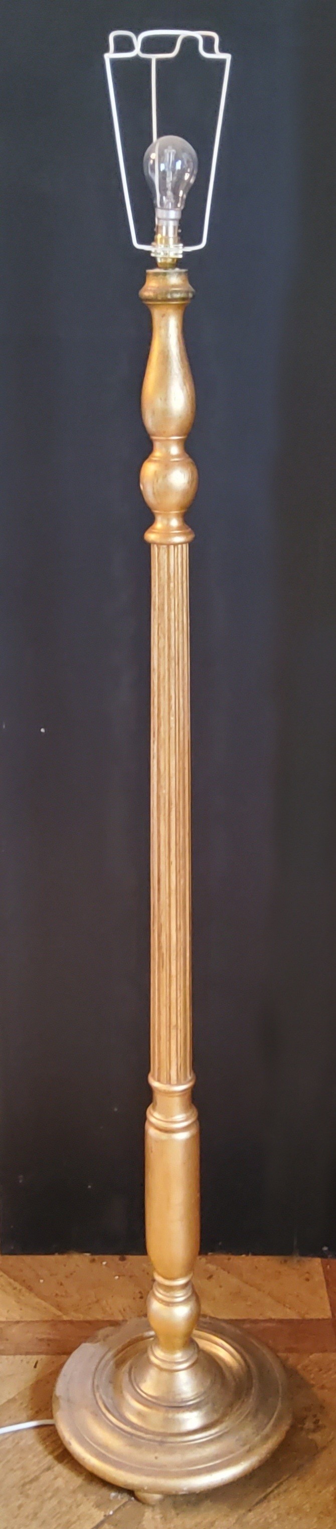 A Regency style gilded standard lamp, with a slender fluted column on a stepped and weighted base