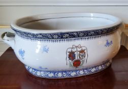 A 19th century French large blue & white two handled ceramic basin decorated with flowers and