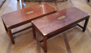 A pair of reproduction mahogany campaign coffee tables, vacant brass cartouche with brass