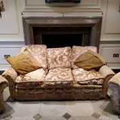 A country house three piece suite in damask upholstery.