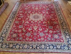 A substantial Persian Najafabad carpet, the red ground carpet with large central medallion motif