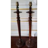 A pair of metal lamps in the form of Regency style candlesticks with 'burr walnut' finish, the