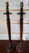 A pair of metal lamps in the form of Regency style candlesticks with 'burr walnut' finish, the