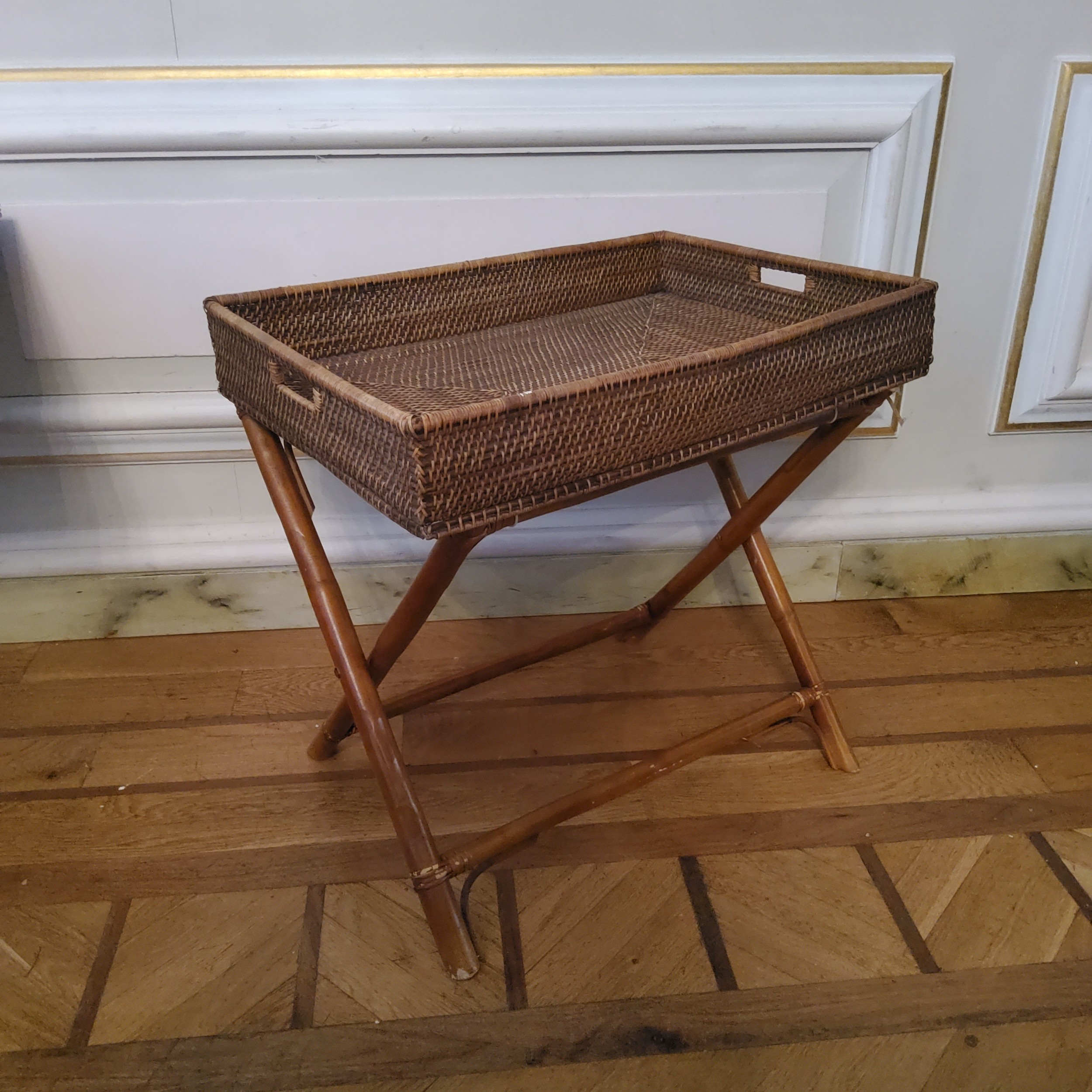 A rattan butlers tray on stand