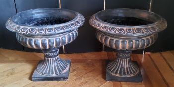 A pair of Victorian style fibreglass pedestal urns, black with terracotta highlights, suitable for
