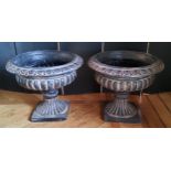 A pair of Victorian style fibreglass pedestal urns, black with terracotta highlights, suitable for