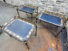 Three black papier-mâché style metal tray/table on foldable cross legs (af)