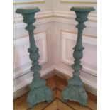 A pair of substantial torchères , constructed from moulded resin, painted green, suitable for