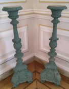 A pair of substantial torchères , constructed from moulded resin, painted green, suitable for