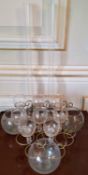 Eight gold painted metal & glass tea light holders; three glass bowls, & a tall glass table centre