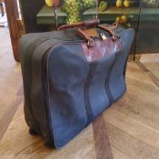 A genuine Mulberry suitcase, large size, in original protective cover, 68w x 50h on casters