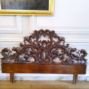 A late 19th century Continental bed head, profusely carved throughout with acanthus scrolls (AF)