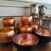 Nine Sheffield pewter tankards; seven plemished copper tea light holders; two painted copper bowls