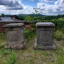 A pair of reconstituted gritstone garden plinths, Neo Classical ribbon tied bow decoration to each