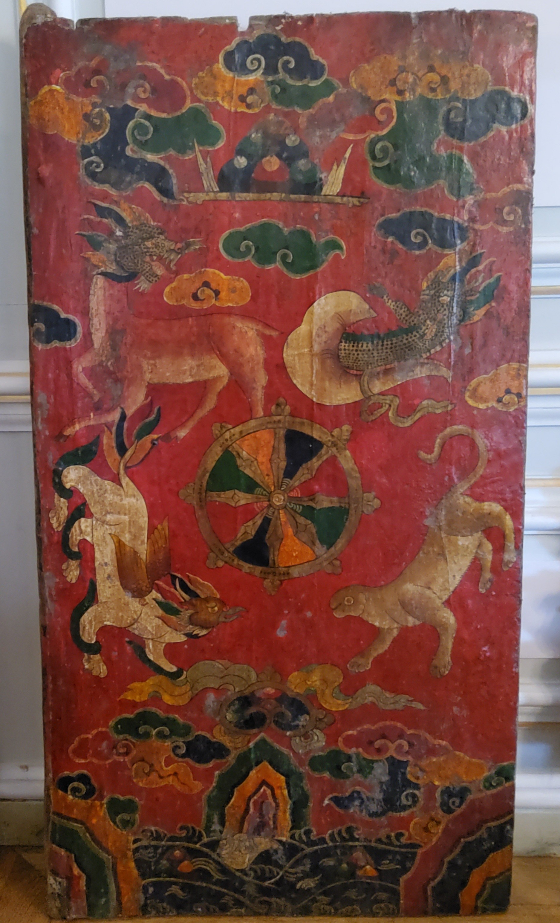 Himalayan Art - A 19th century Tibetan temple door panel, vibrantly hand painted with a central