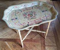 A contemporary decorative Papier-mâché style tray table, the tray decorated with red, green & yellow