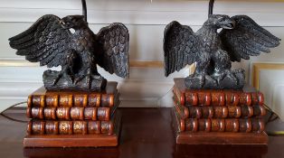 A pair of table lamps, the wooden base in the form three antiquarian books surmounted by a bronze