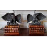 A pair of table lamps, the wooden base in the form three antiquarian books surmounted by a bronze