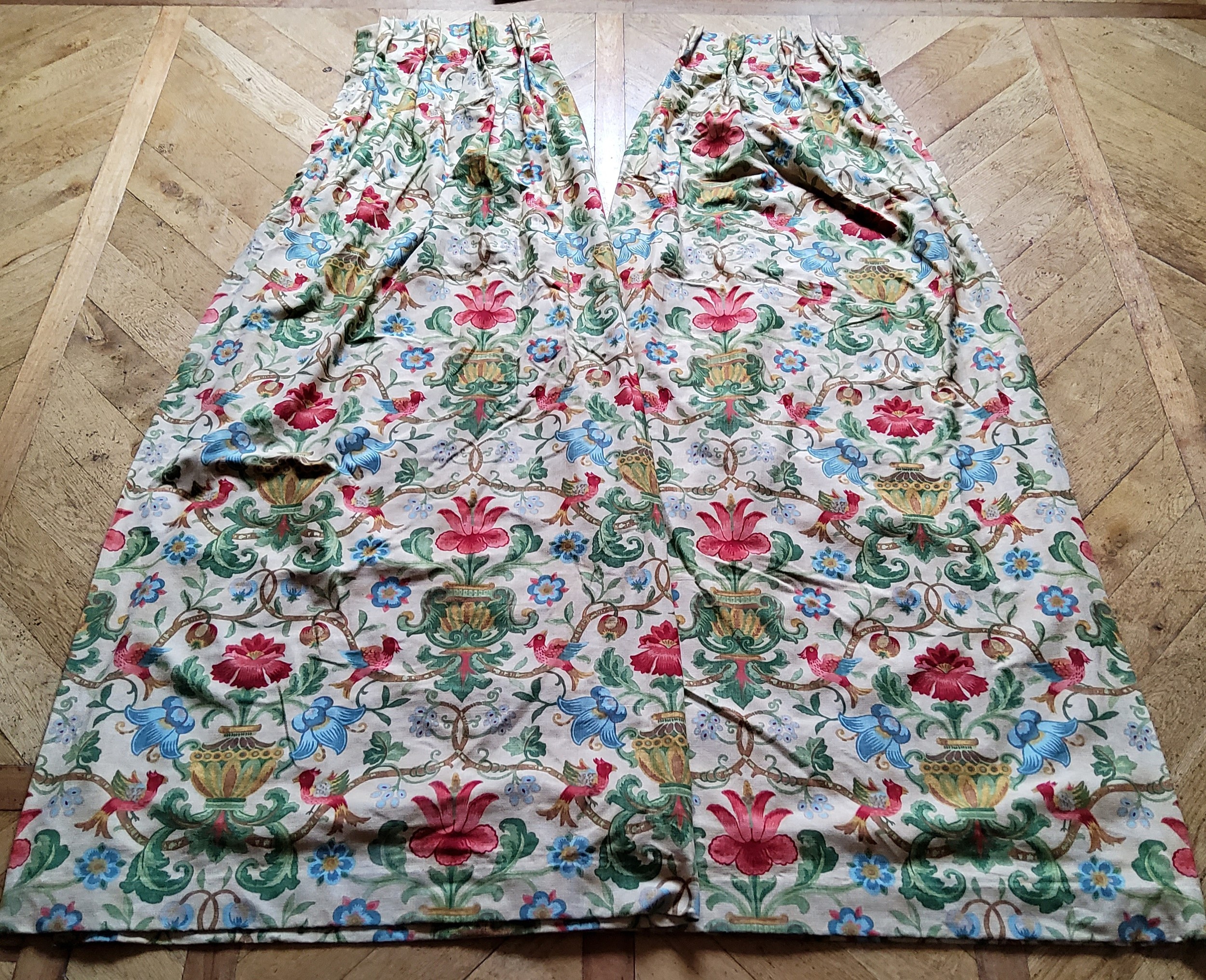 A pair of William Morris style pinch pleat linen curtains, printed with classical urns, flora and