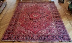 A large hand finished Mashad Persian carpet 390cm x 293cm