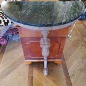 A 'limed oak' wall hanging console table, caryatid leg supporting a demi-lune green marble top