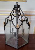 A glazed wrought iron 3 light hall lantern, gold painted finials 46cms high (PAT tested)