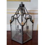 A glazed wrought iron 3 light hall lantern, gold painted finials 46cms high (PAT tested)