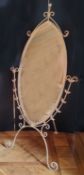 An oval shaped painted metal cheval mirror, distressed cream finish 185cms high