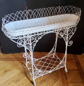 A Victorian style wrought metal elongated oval jardiniere stand, the white painted metal wirework