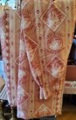 A pair of pencil pleat linen curtains toile du jouy style fabric in tones of red on a cream ground