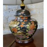 A large Satsuma lamp base in the form of a ginger jar, decorated with peonies & clouds on a dark