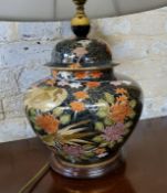 A large Satsuma lamp base in the form of a ginger jar, decorated with peonies & clouds on a dark