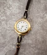 A 9ct gold lady's wristwatch, Swiss movement, white enamel dial, black & red Roman numerals,