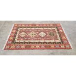 A Qashgai Kilim wool rug in tones of terracotta, cream and blues