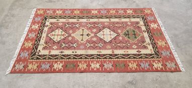 A Qashgai Kilim wool rug in tones of terracotta, cream and blues