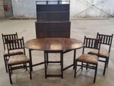 Ercol - a mid-century suite comprising of a dining table with four chairs, Ercol blue label;