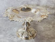A silver-plated shaped pedestal dish embossed in relief decoration 19cms high