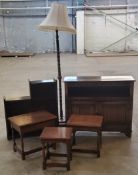 Furniture - a nest of three oak occasional tables; an elm standard lamp; a linen-fold hall
