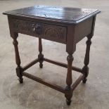 An early 20th century oak hall cupboard, carved top above single fox-mask handled drawer