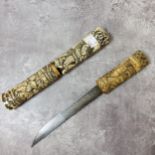 A Meiji period Tanto carved bone Tsuka & two section saya carved with Samurai warriors